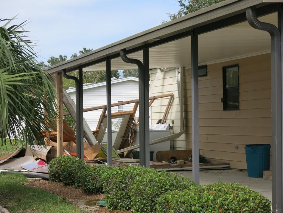Attached laundry room was completely destroyed with no significant damage to main structure or the carport.