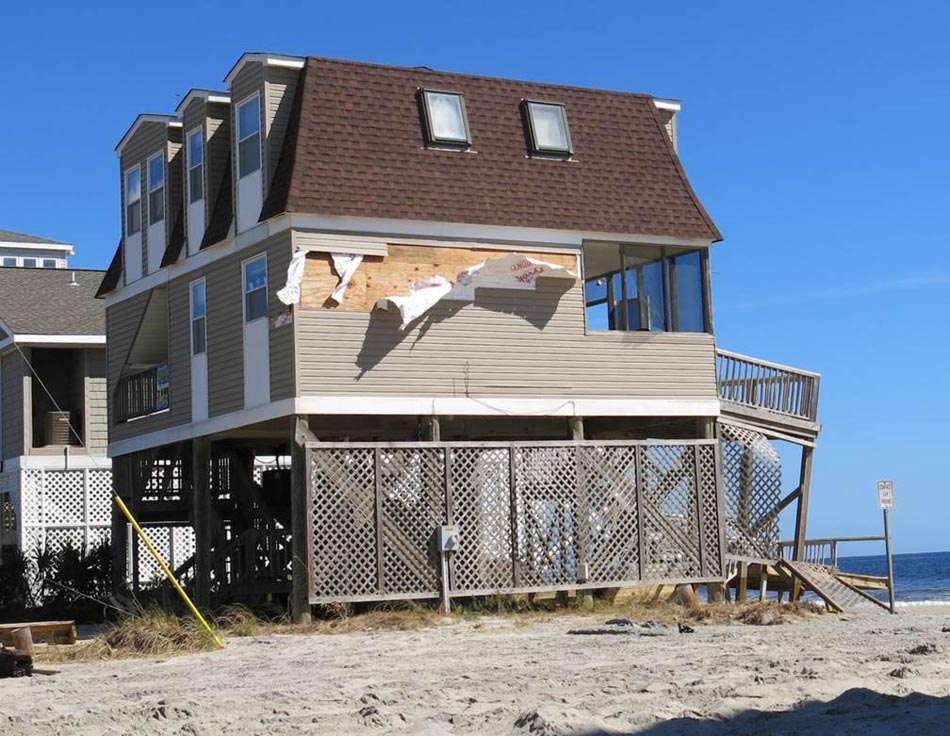 Significant wind damage to vinyl wall siding of a beachfront rental home