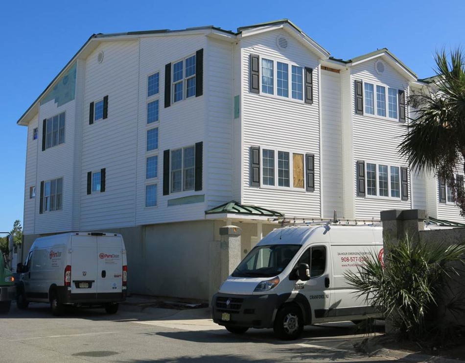 Wind damage to a condo building, including missing wall siding