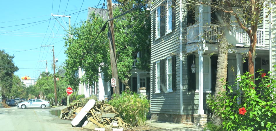 Waterlogged belongings curbside following surge damage