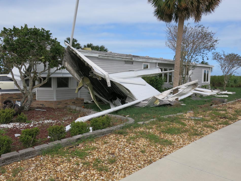 Carport failed and caused minor damage to the roof flashing.