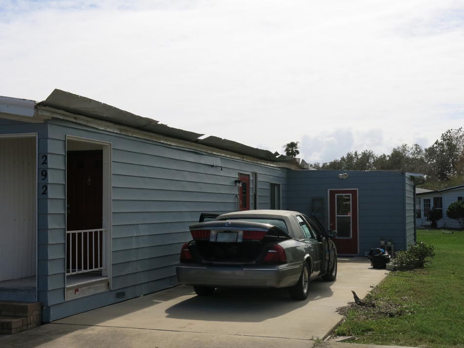 Carport damage peeled away from main structure, damaged adjoining shed.